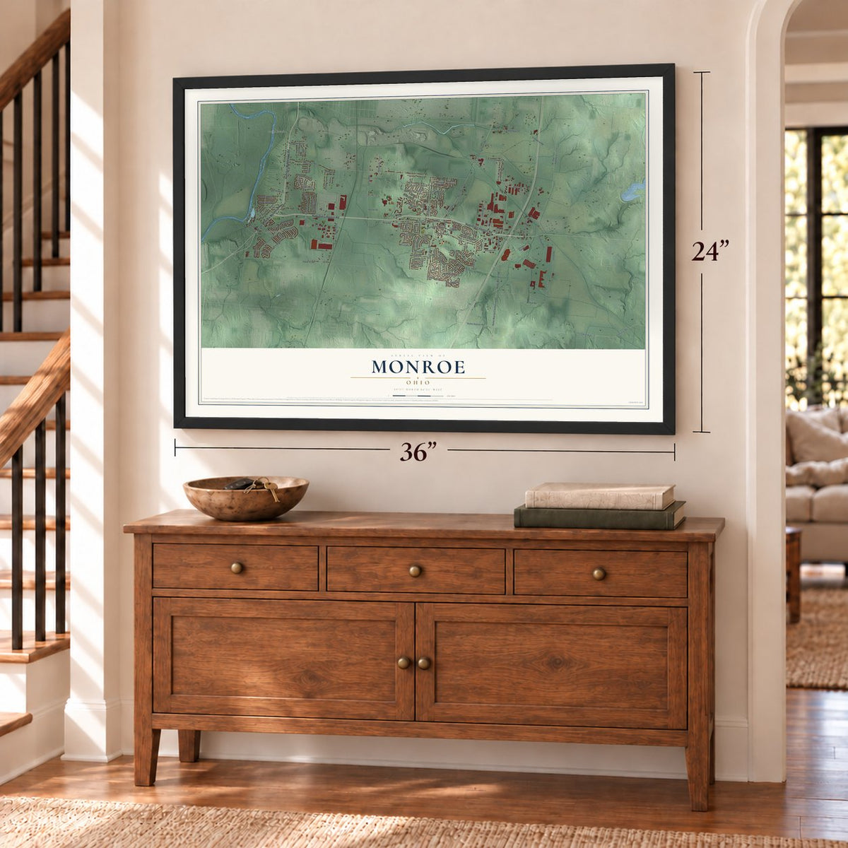 Monroe, Ohio map, 24 x 36 inch print in a black frame above a dresser by a staircase