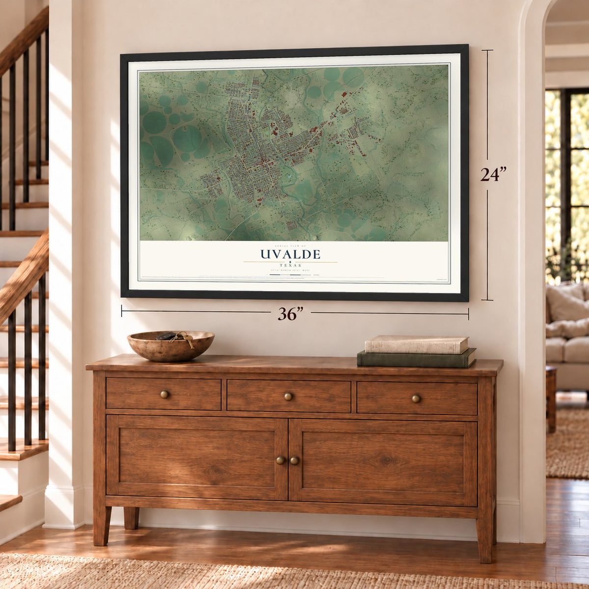 Uvalde, Texas map, 24 x 36 inch print in a black frame above a dresser by a staircase