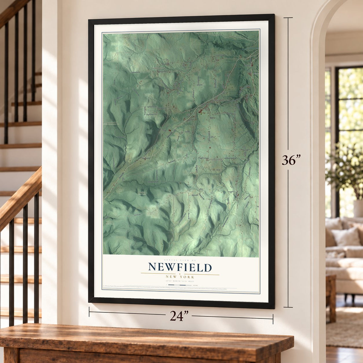Newfield, New York map, 24 x 36 inch print in a black frame by a staircase