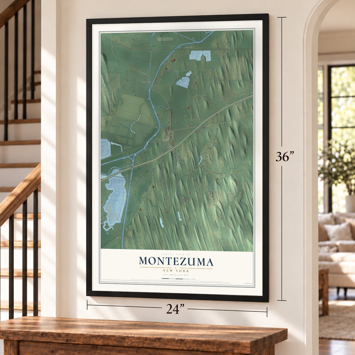 Montezuma, New York map, 24 x 36 inch print in a black frame by a staircase