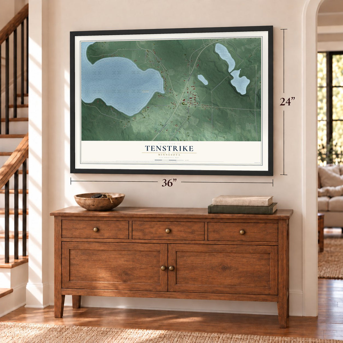 Tenstrike, Minnesota map, 24 x 36 inch print in a black frame above a dresser by a staircase