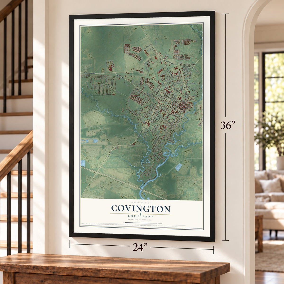 Covington, Louisiana map, 24 x 36 inch print in a black frame by a staircase