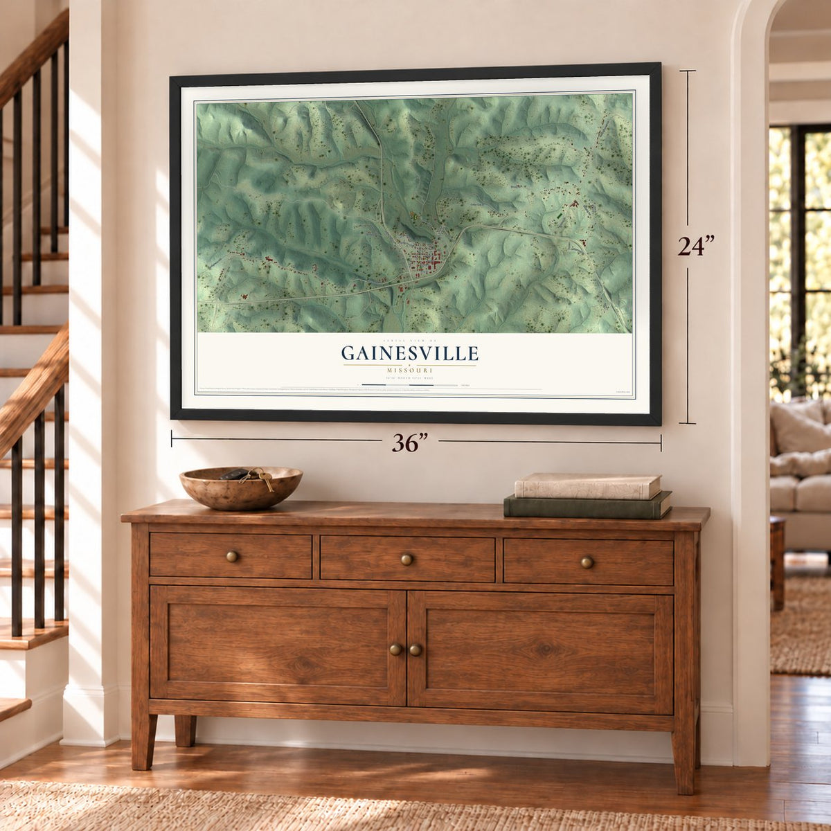 Gainesville, Missouri map, 24 x 36 inch print in a black frame above a dresser by a staircase