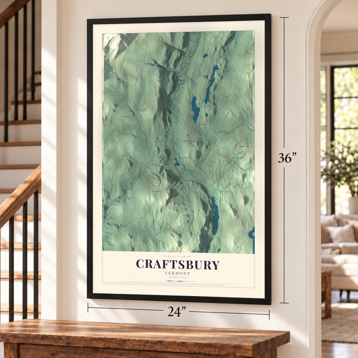 Craftsbury, Vermont map, 24 x 36 inch print in a black frame by a staircase