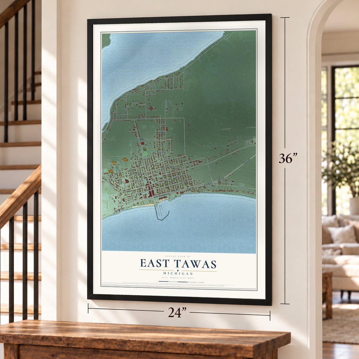 East Tawas, Michigan map, 24 x 36 inch print in a black frame by a staircase