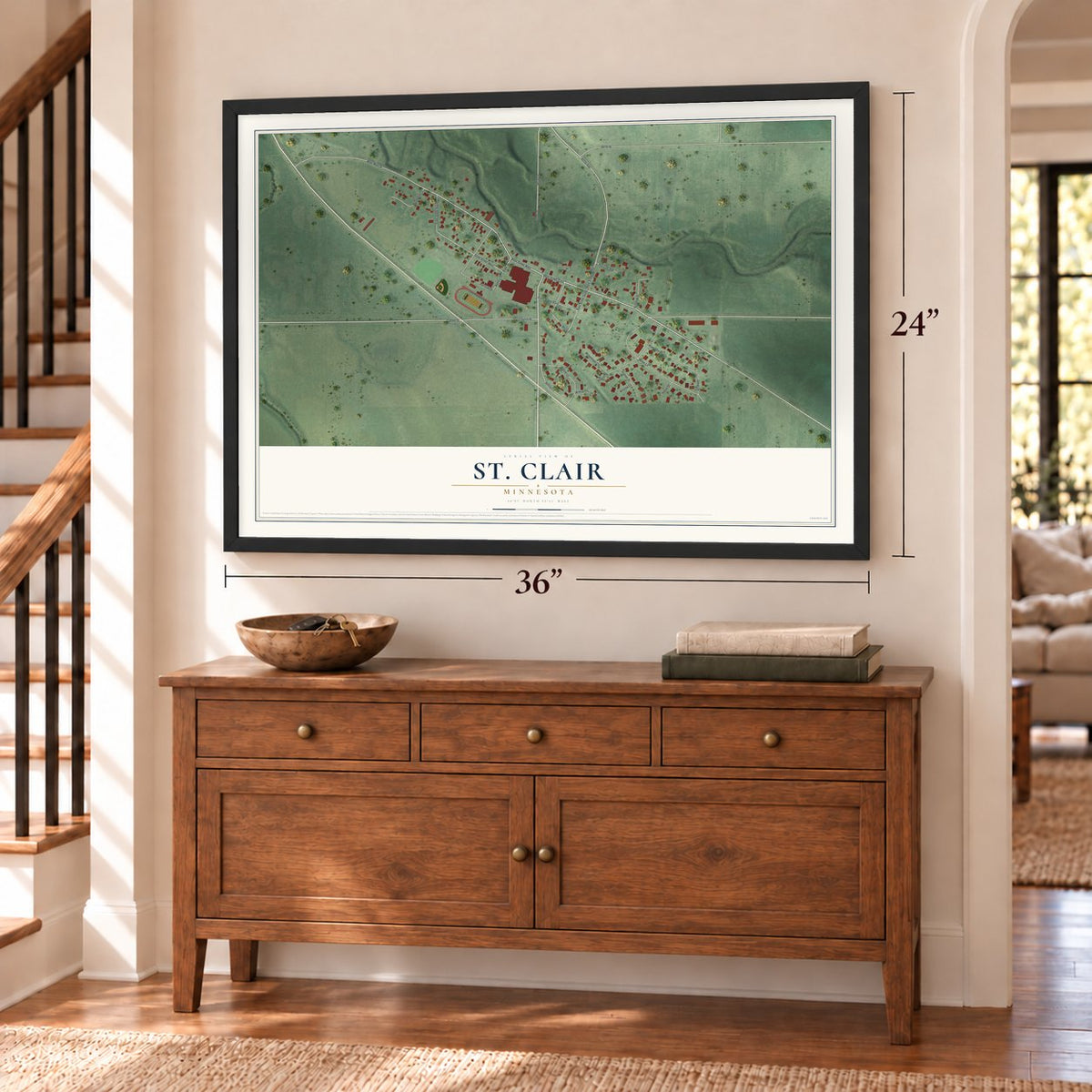 St. Clair, Minnesota map, 24 x 36 inch print in a black frame above a dresser by a staircase