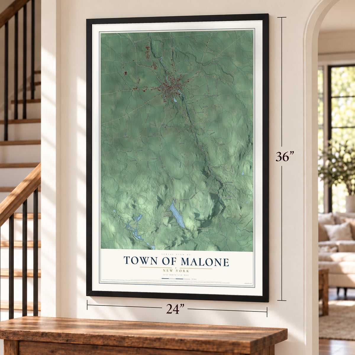 Town of Malone, New York map, 24 x 36 inch print in a black frame by a staircase