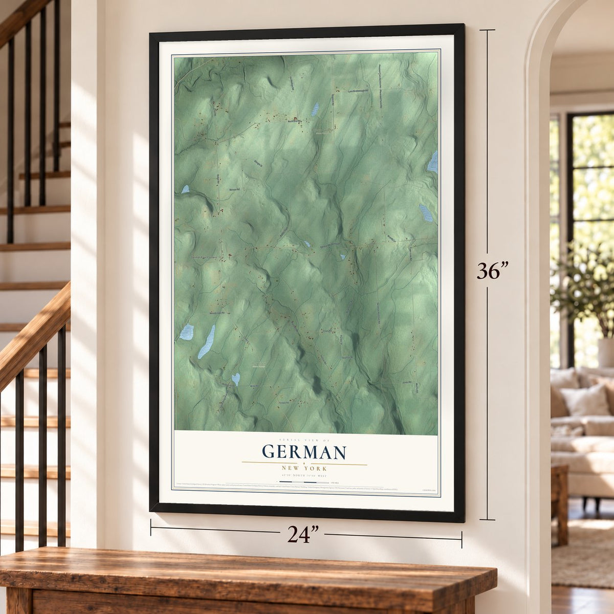 German, New York map, 24 x 36 inch print in a black frame by a staircase