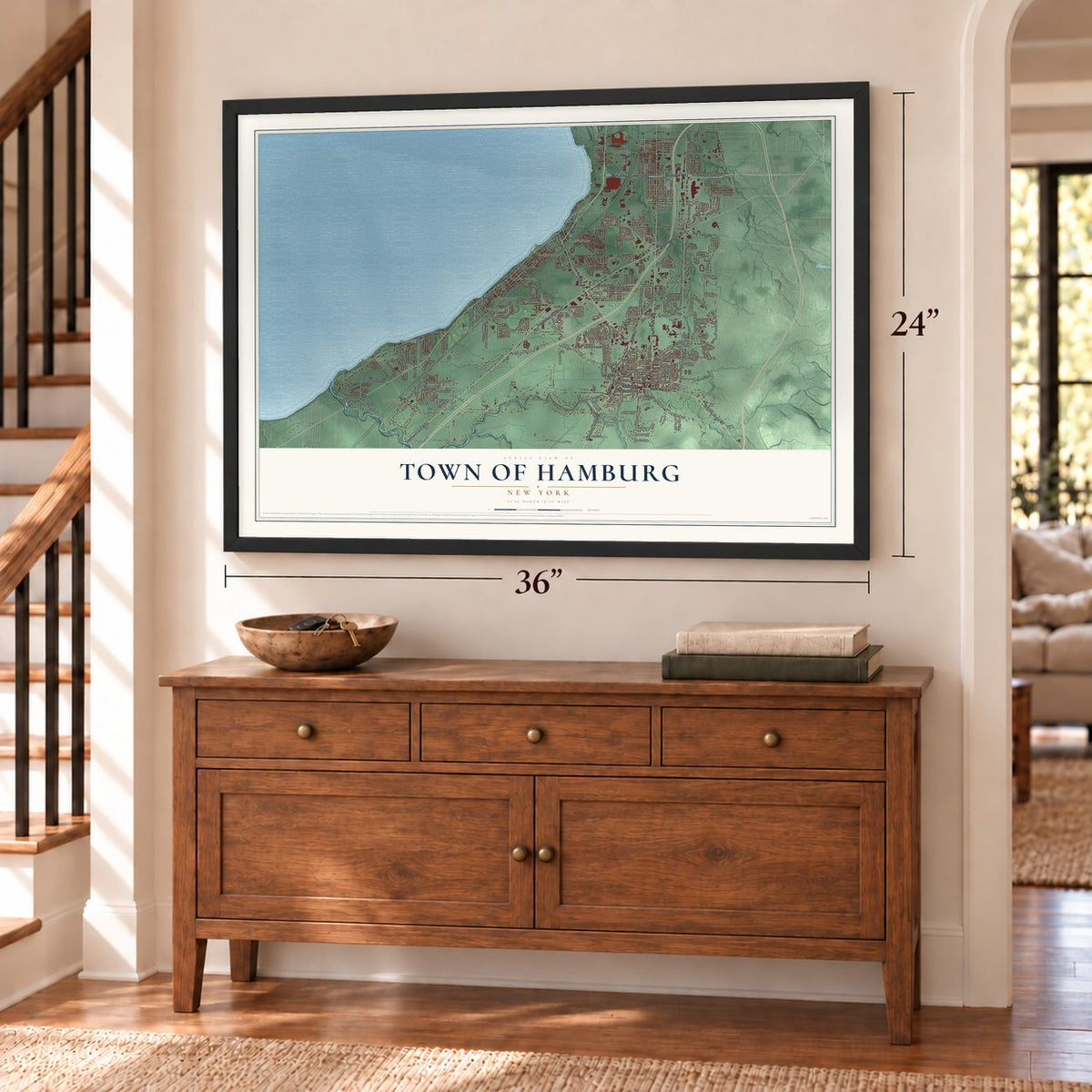 Town of Hamburg, New York map, 24 x 36 inch print in a black frame above a dresser by a staircase