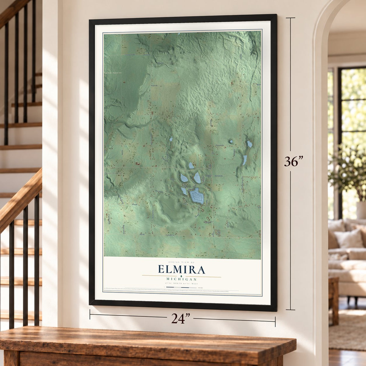 Elmira, Michigan map, 24 x 36 inch print in a black frame by a staircase