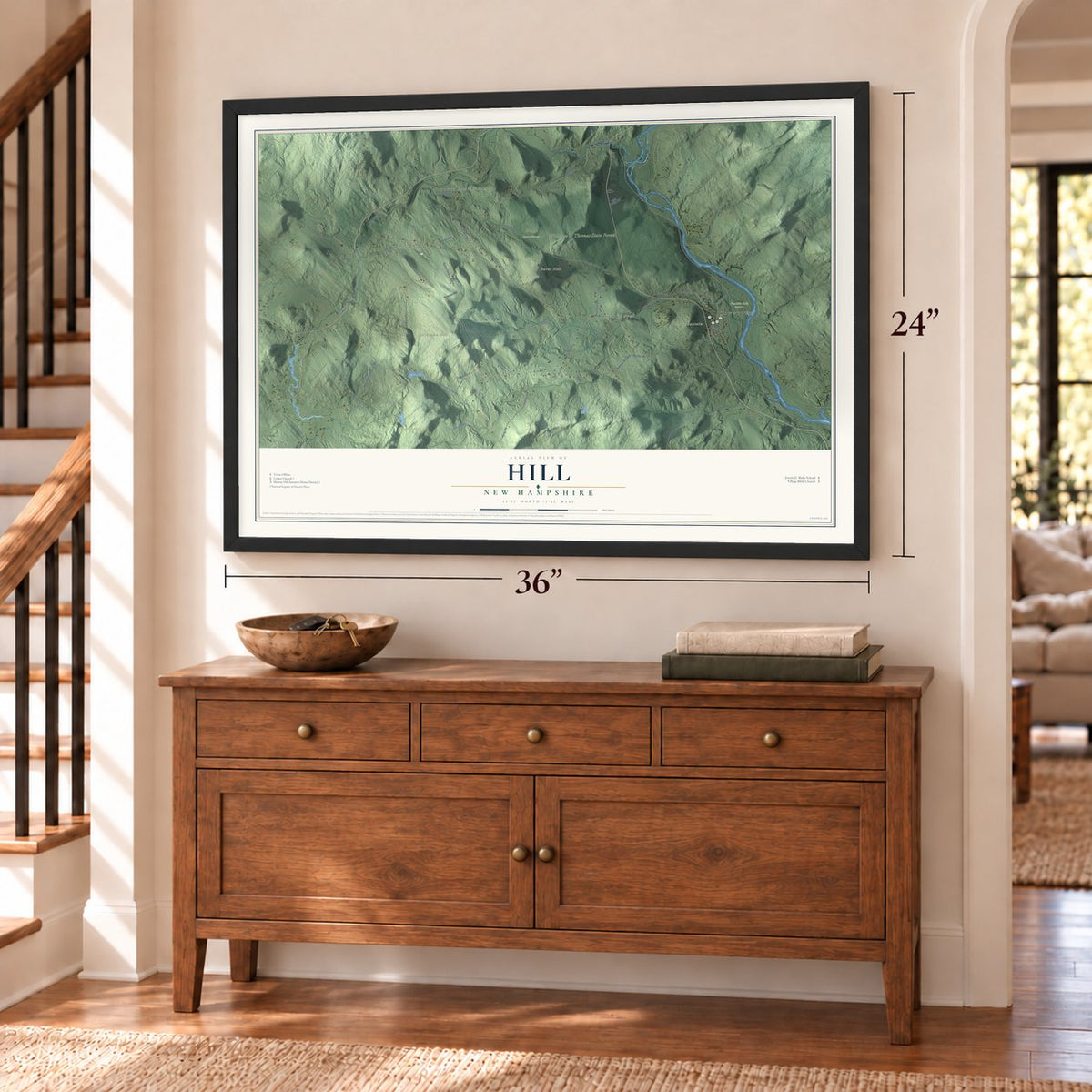 Hill, New Hampshire map, 24 x 36 inch print in a black frame above a dresser by a staircase