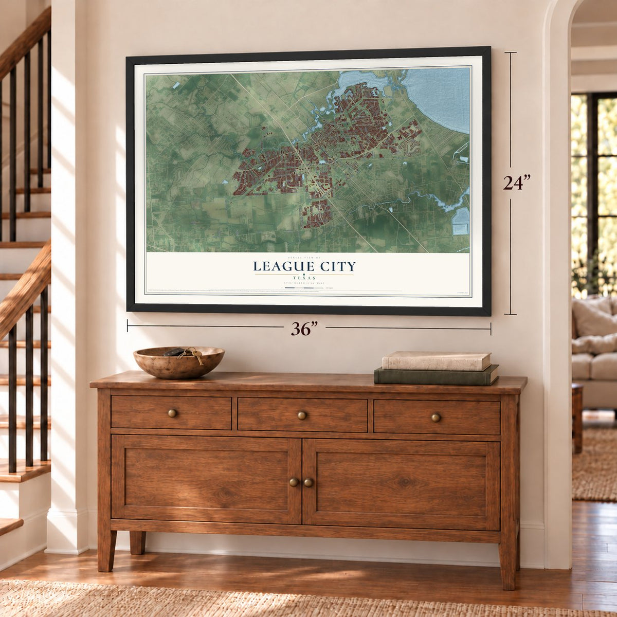 League City, Texas map, 24 x 36 inch print in a black frame above a dresser by a staircase
