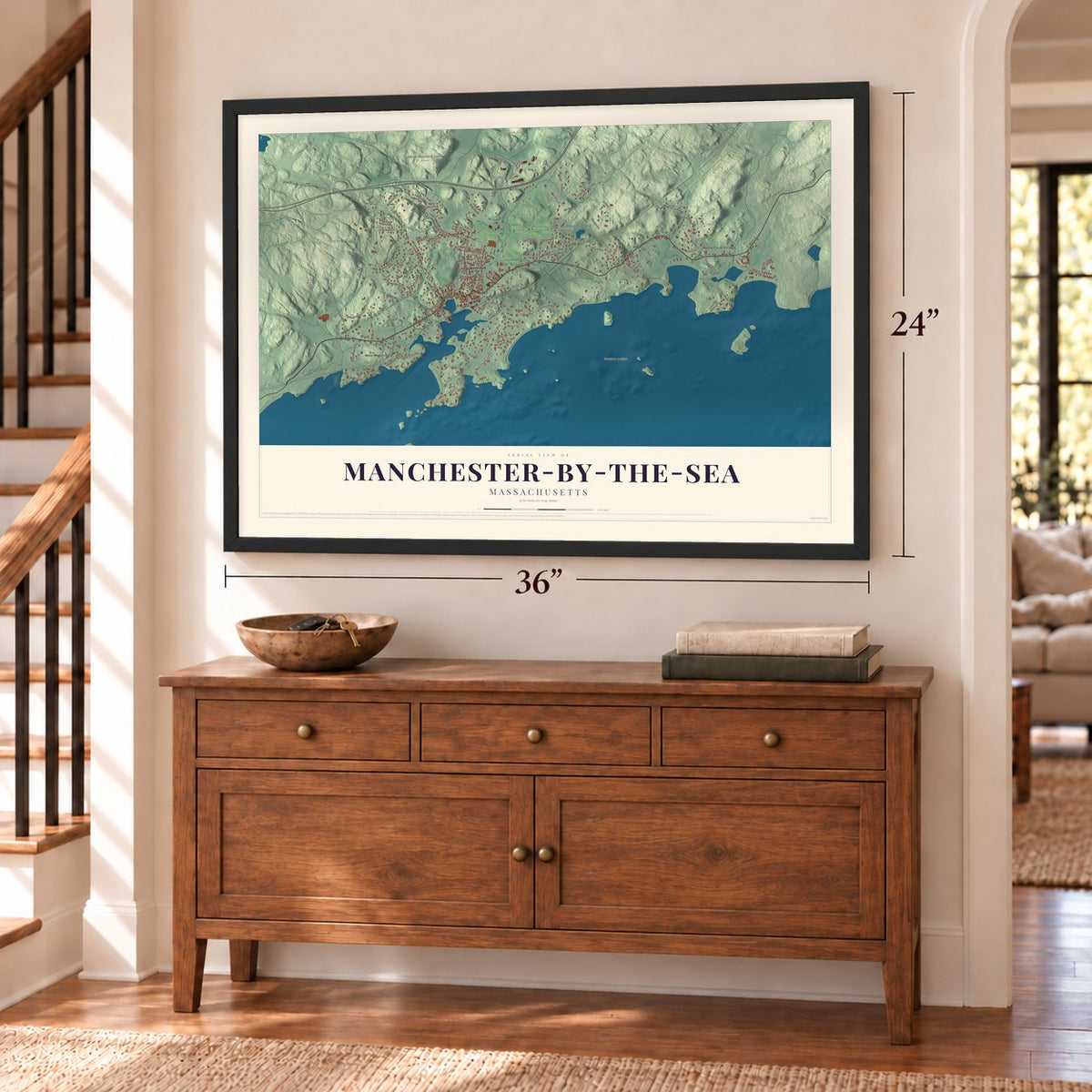 Manchester-by-the-Sea, Massachusetts map, 24 x 36 inch print in a black frame above a dresser by a staircase