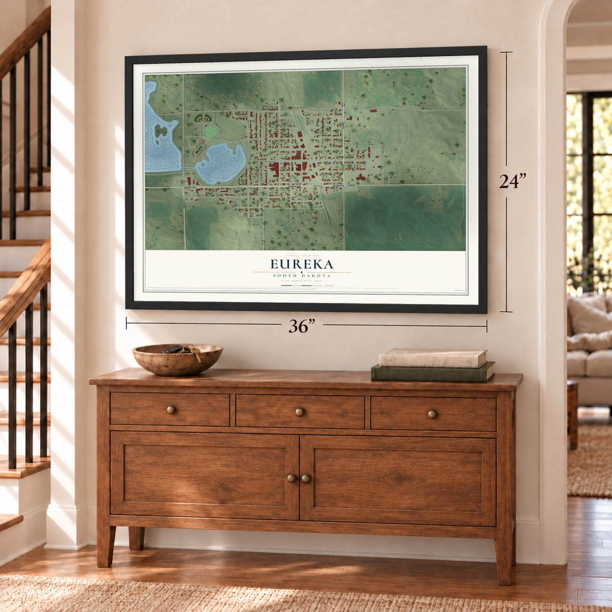 Eureka, South Dakota map, 24 x 36 inch print in a black frame above a dresser by a staircase