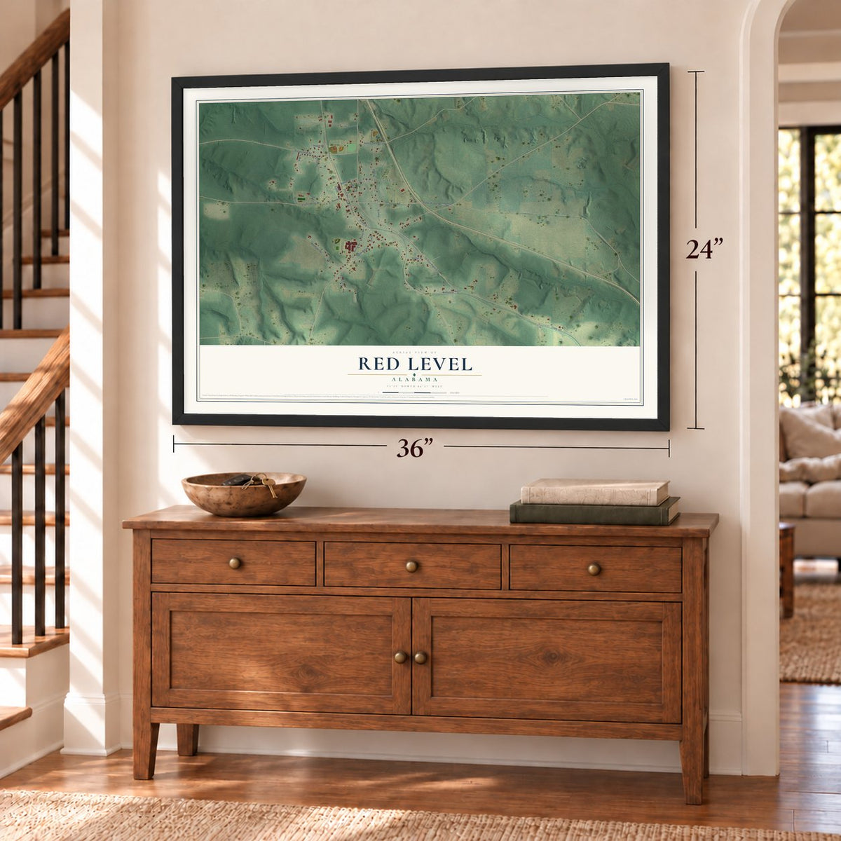 Red Level, Alabama map, 24 x 36 inch print in a black frame above a dresser by a staircase