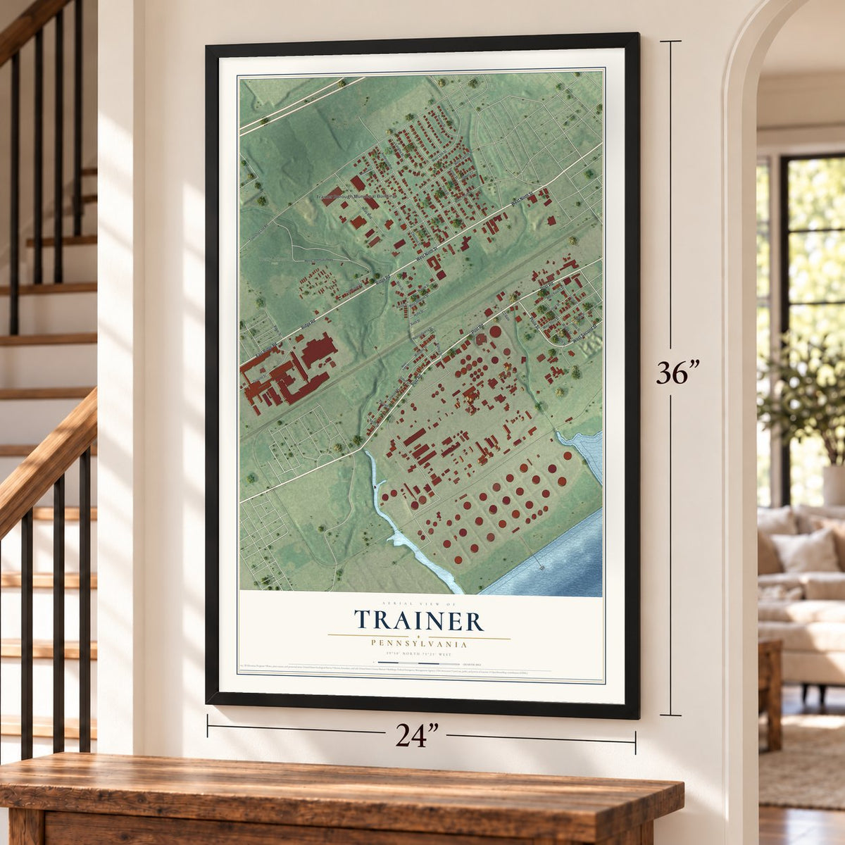 Trainer, Pennsylvania map, 24 x 36 inch print in a black frame by a staircase