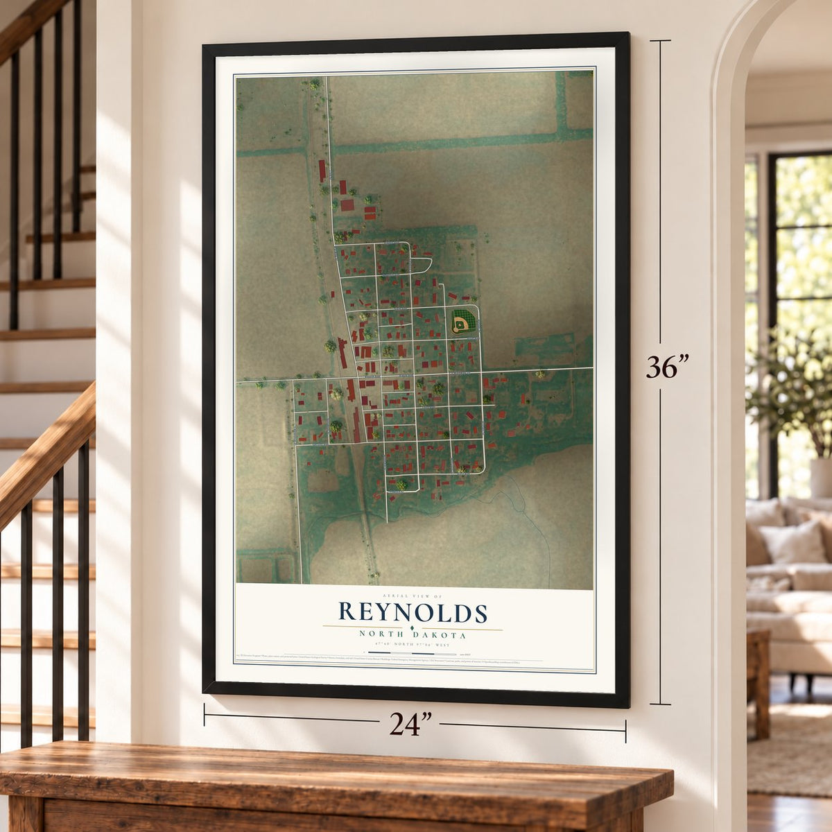 Reynolds, North Dakota map, 24 x 36 inch print in a black frame by a staircase