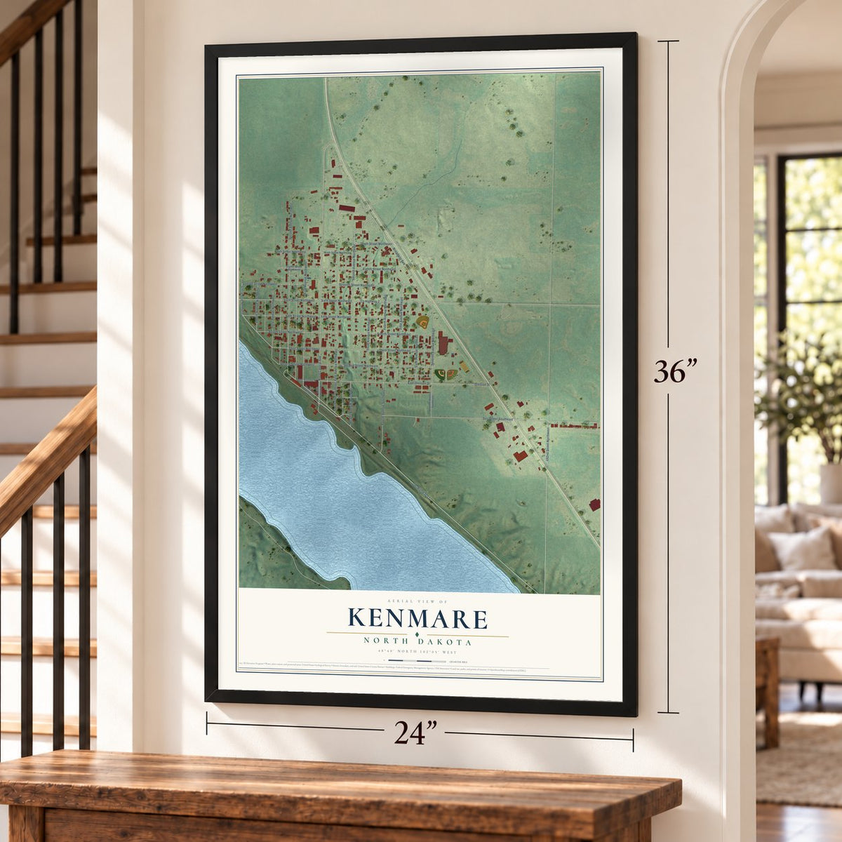 Kenmare, North Dakota map, 24 x 36 inch print in a black frame by a staircase