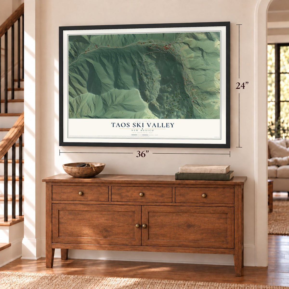Taos Ski Valley, New Mexico map, 24 x 36 inch print in a black frame above a dresser by a staircase