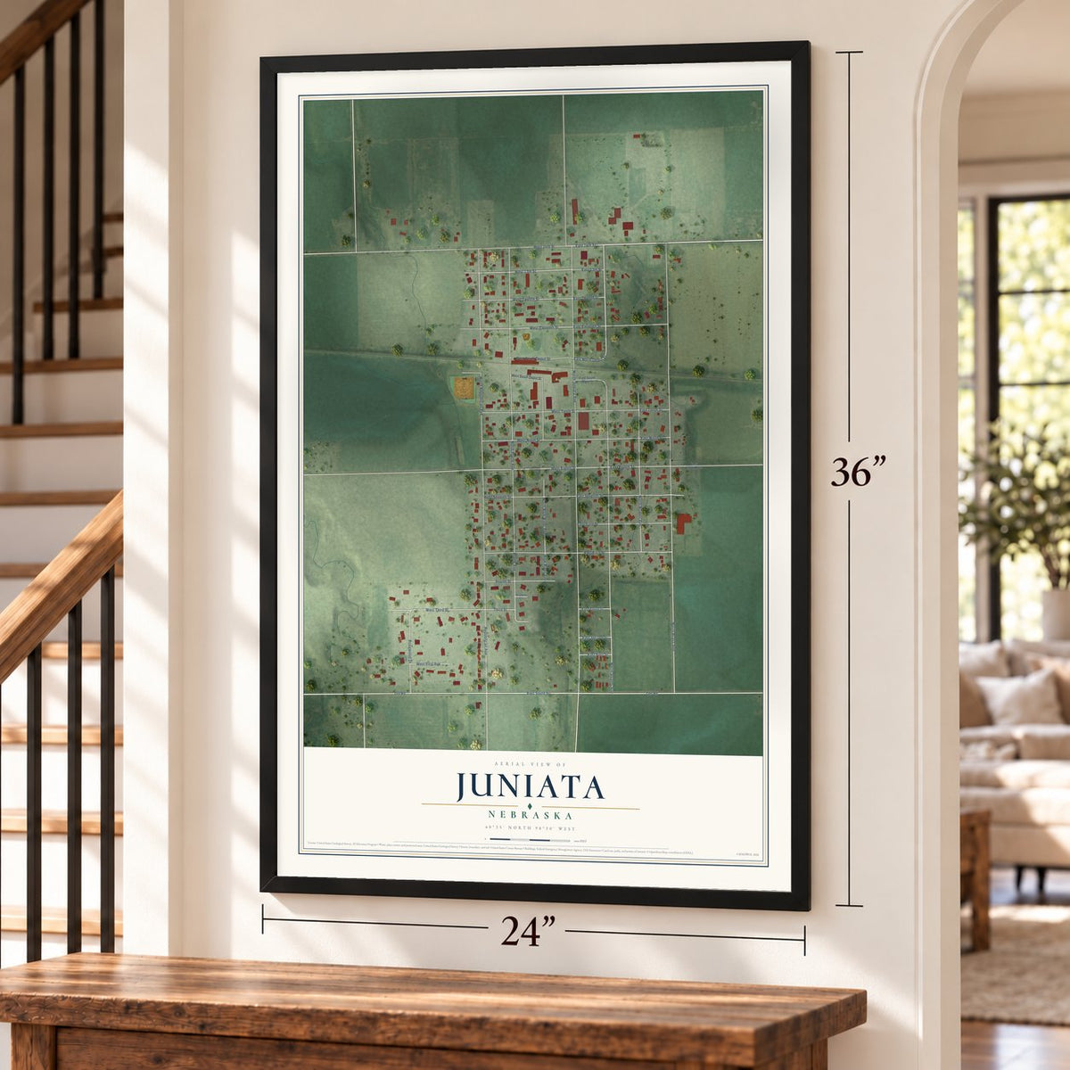 Juniata, Nebraska map, 24 x 36 inch print in a black frame by a staircase