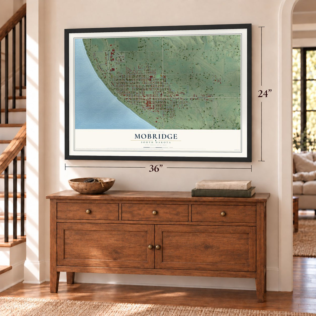 Mobridge, South Dakota map, 24 x 36 inch print in a black frame above a dresser by a staircase