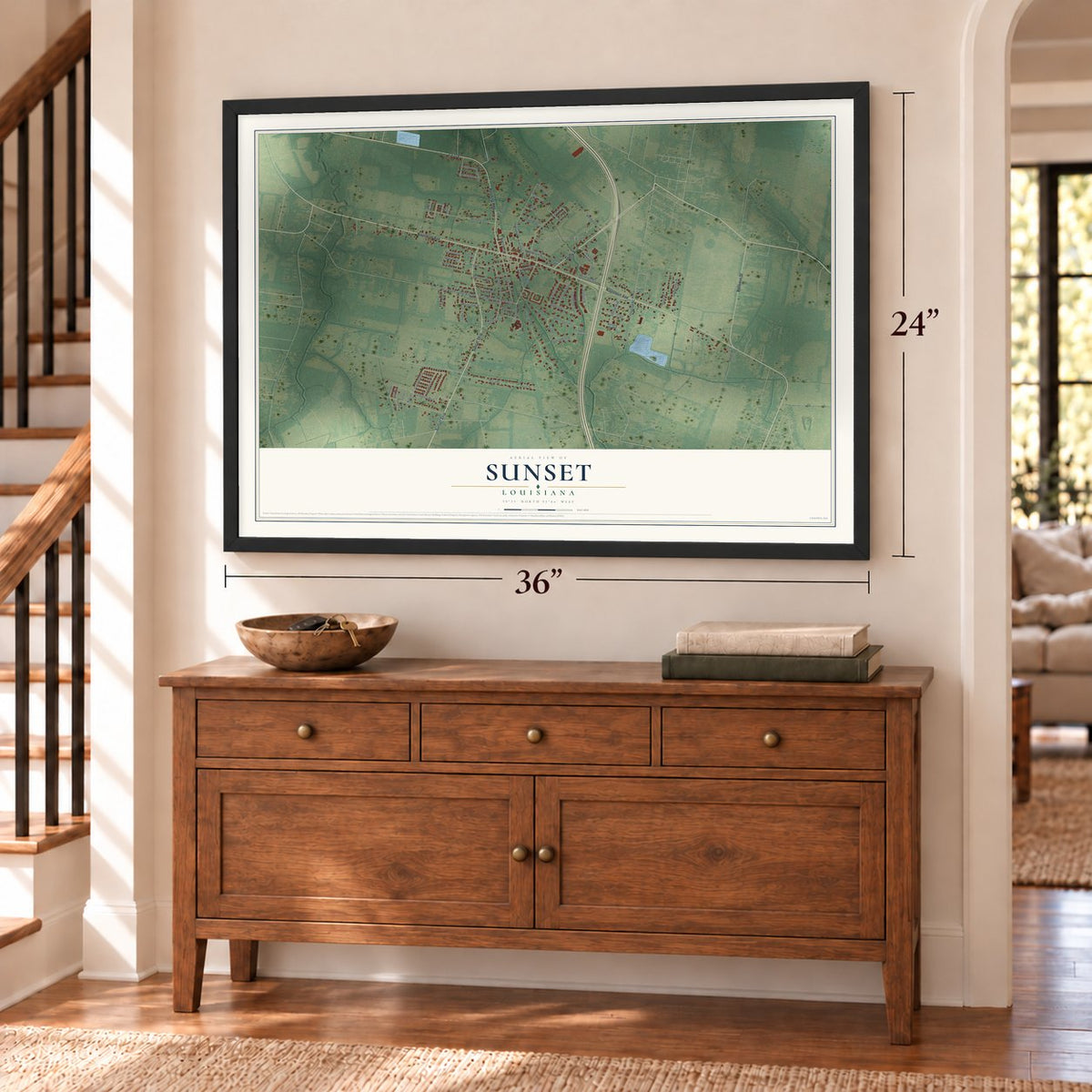 Sunset, Louisiana map, 24 x 36 inch print in a black frame above a dresser by a staircase