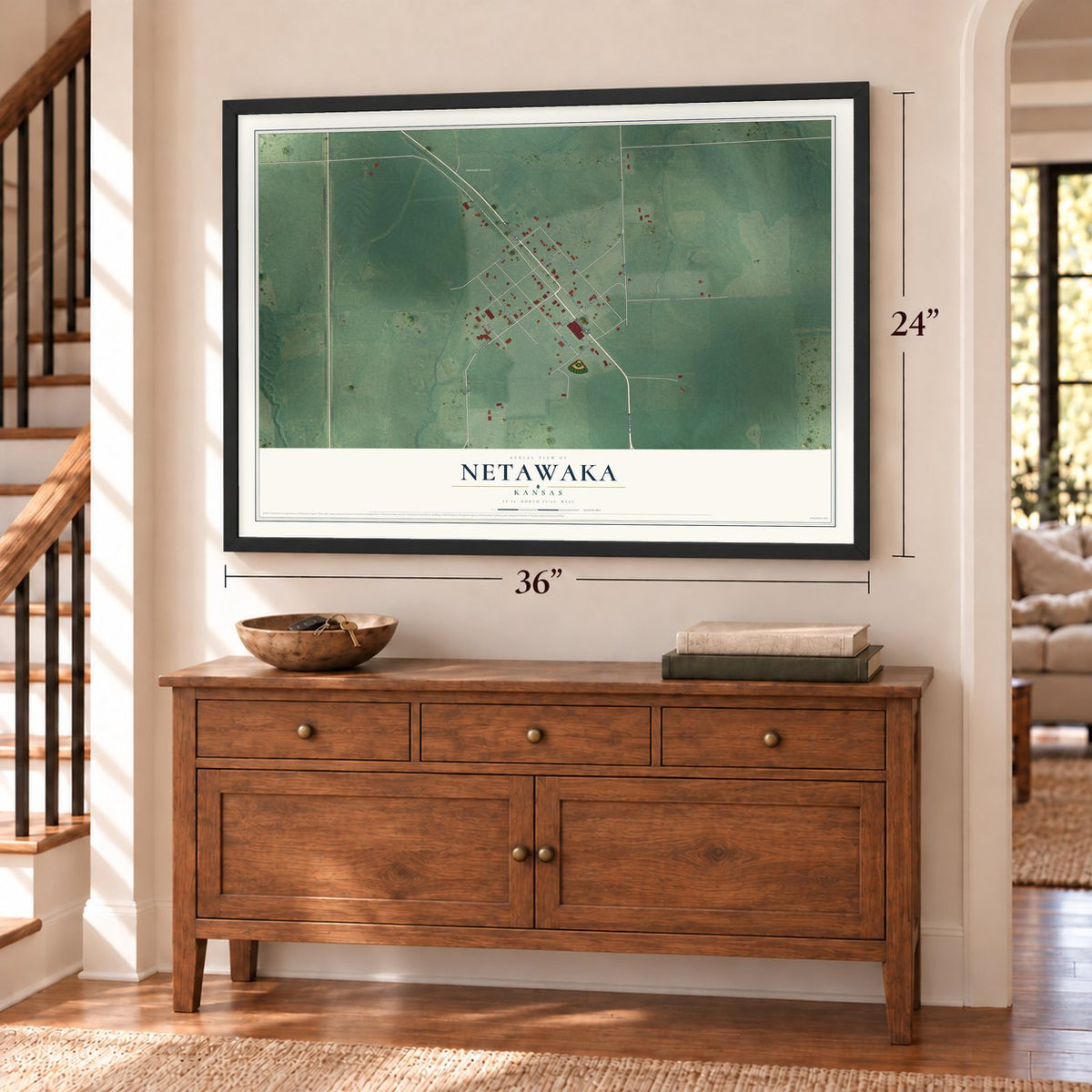 Netawaka, Kansas map, 24 x 36 inch print in a black frame above a dresser by a staircase