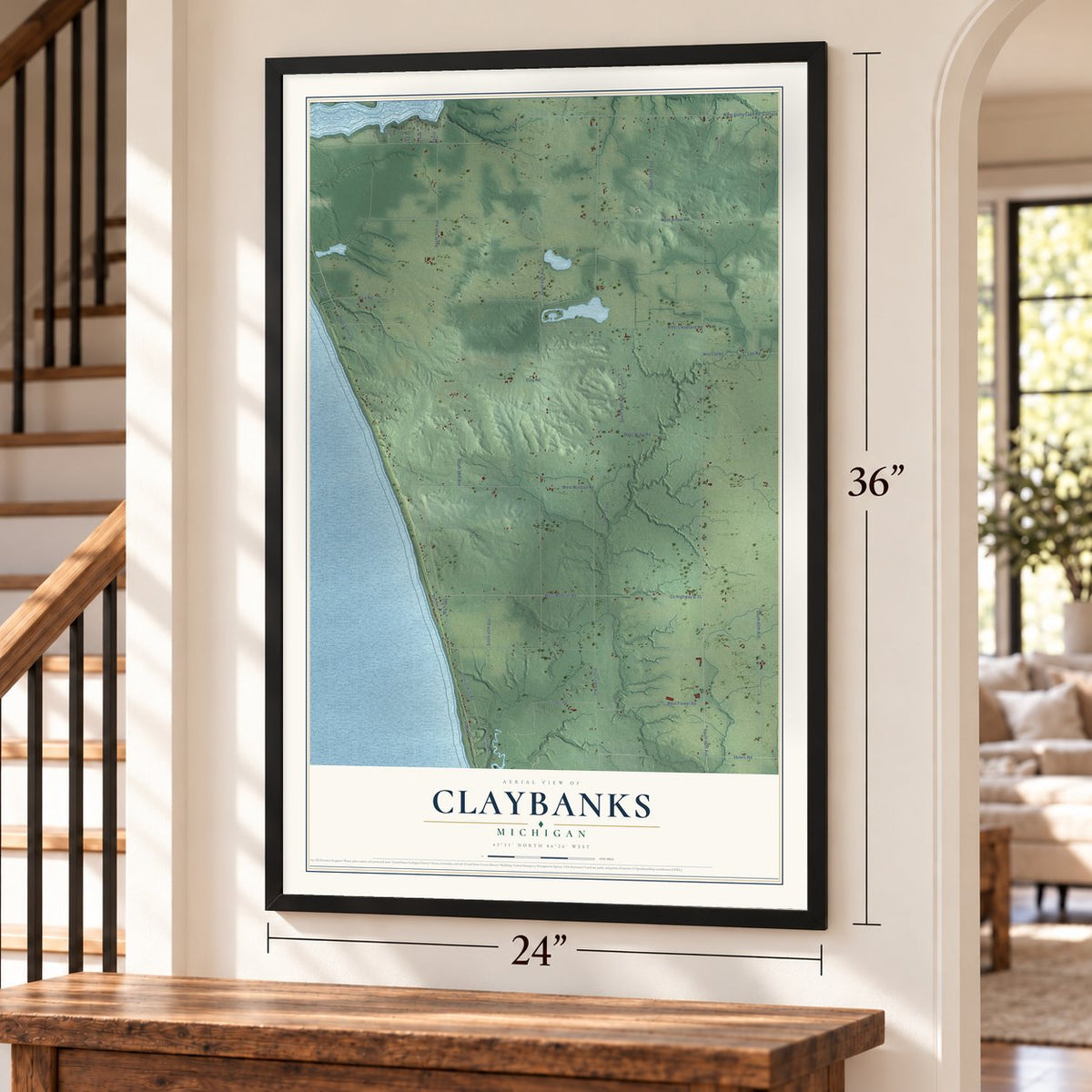 Claybanks, Michigan map, 24 x 36 inch print in a black frame by a staircase