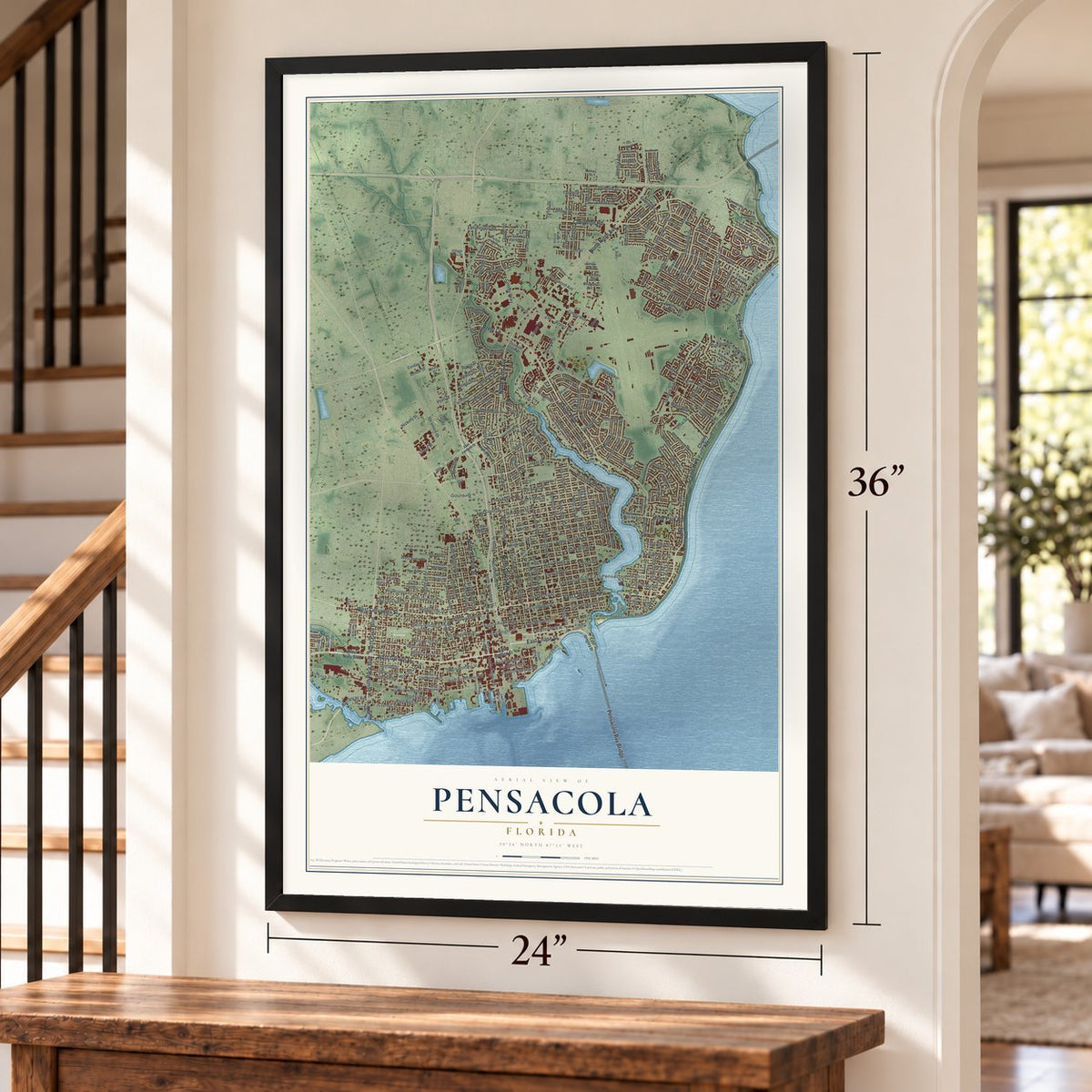 Pensacola, Florida map, 24 x 36 inch print in a black frame by a staircase