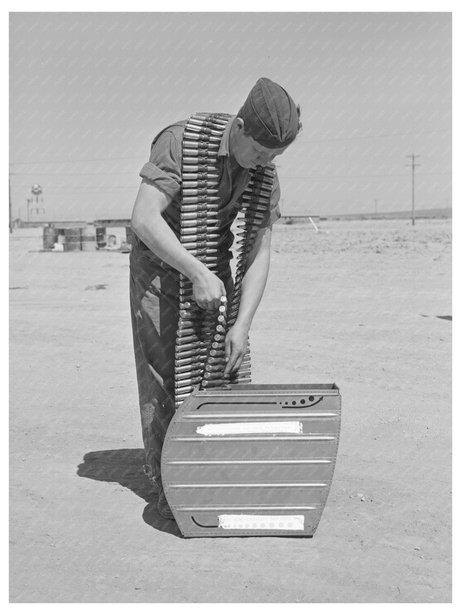 Armorer Loading .50 Caliber Bullets Lake Muroc 1942 - Available at KNOWOL