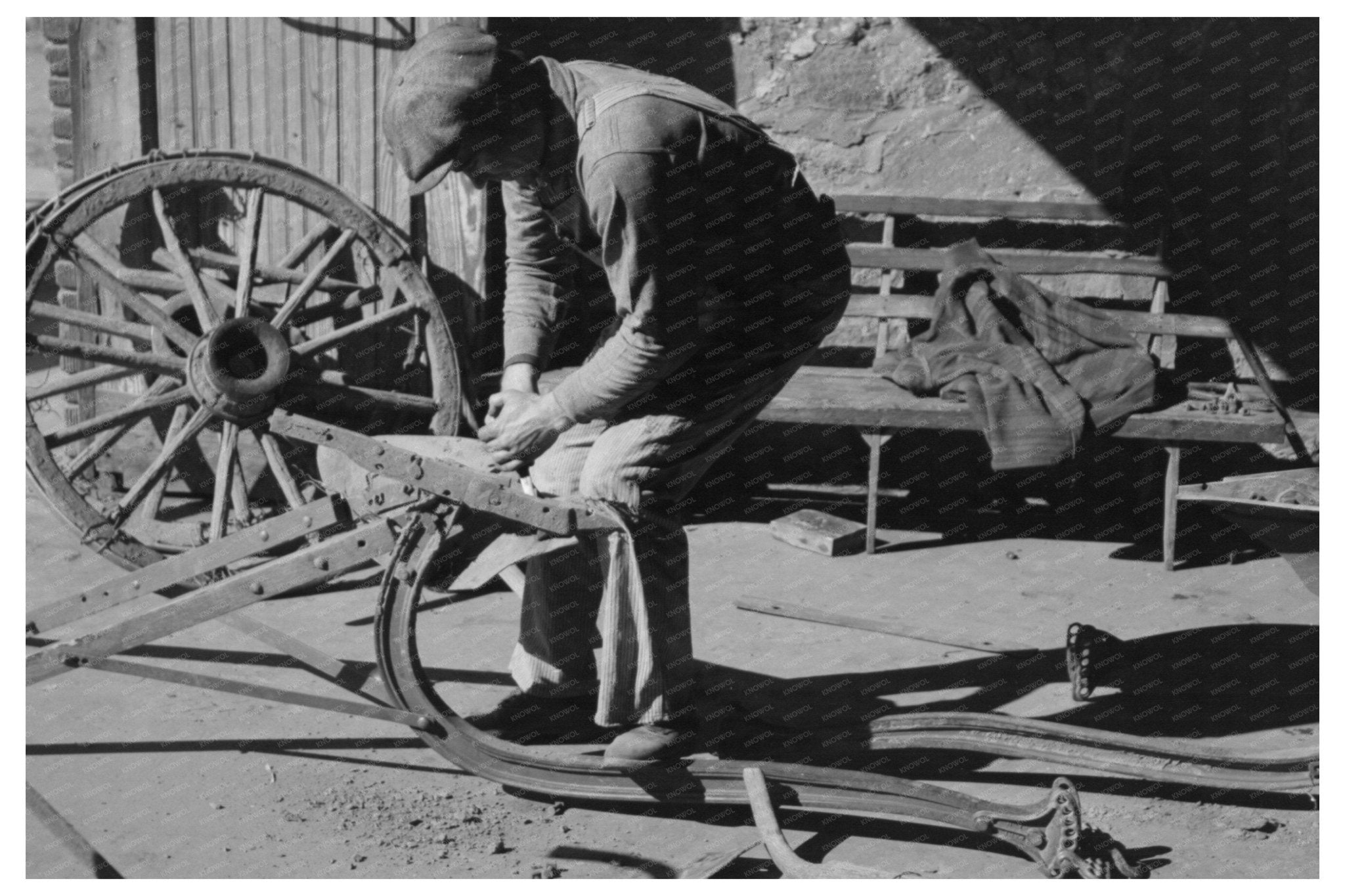 Blacksmith Helper Disassembling Plow February 1940 - Available at KNOWOL