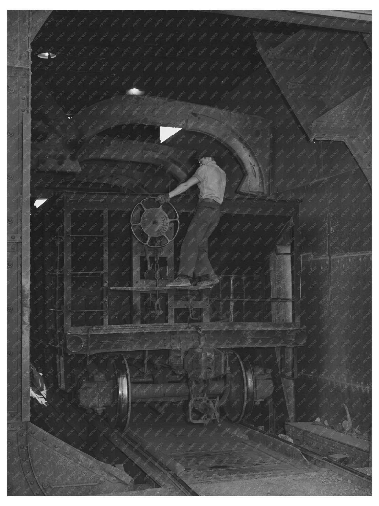 Brakeman Adjusts Ore Car Brakes Anaconda Montana 1942 - Available at KNOWOL