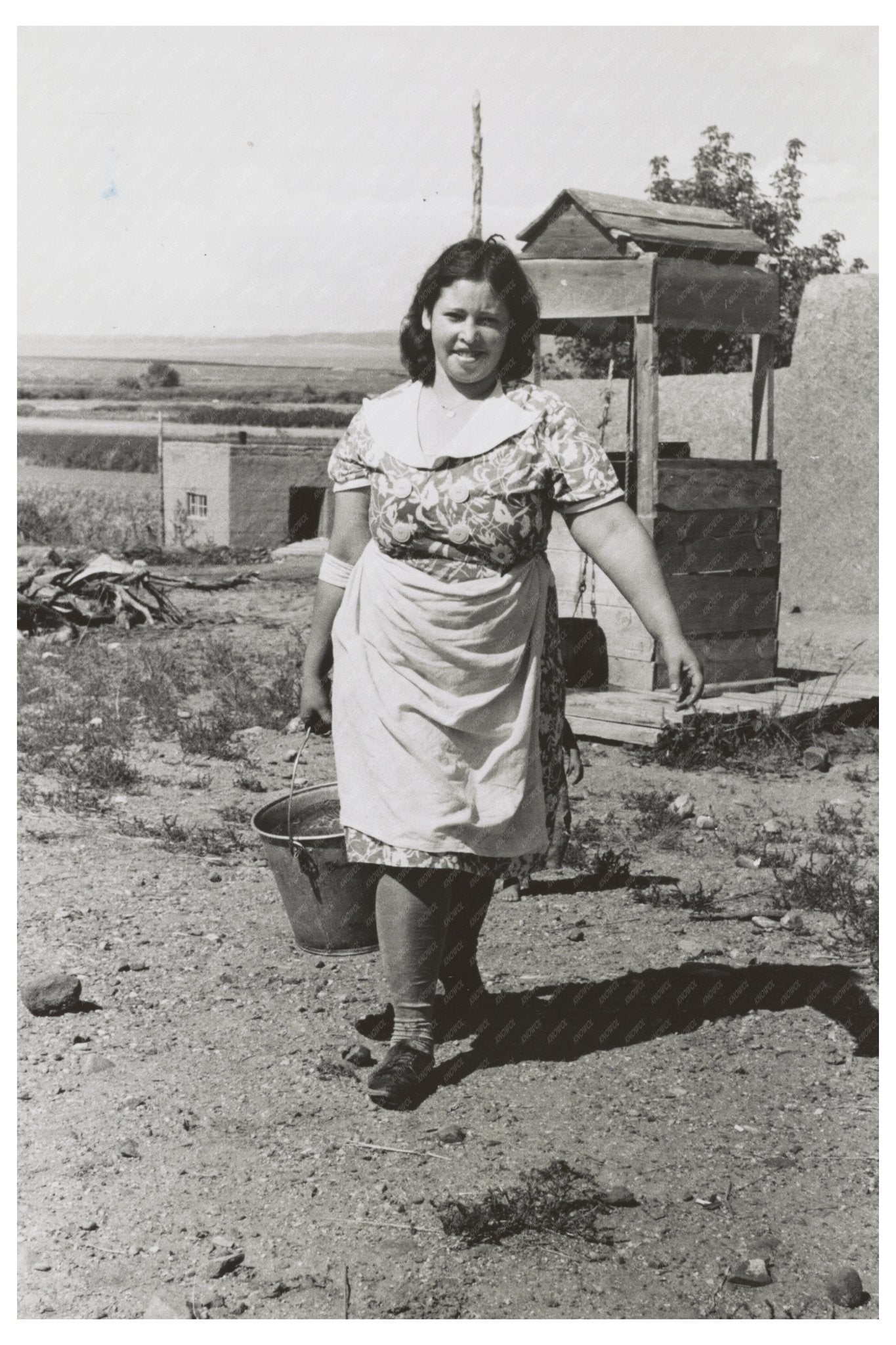 Child Carries Water from Well in Taos County 1939 - Available at KNOWOL