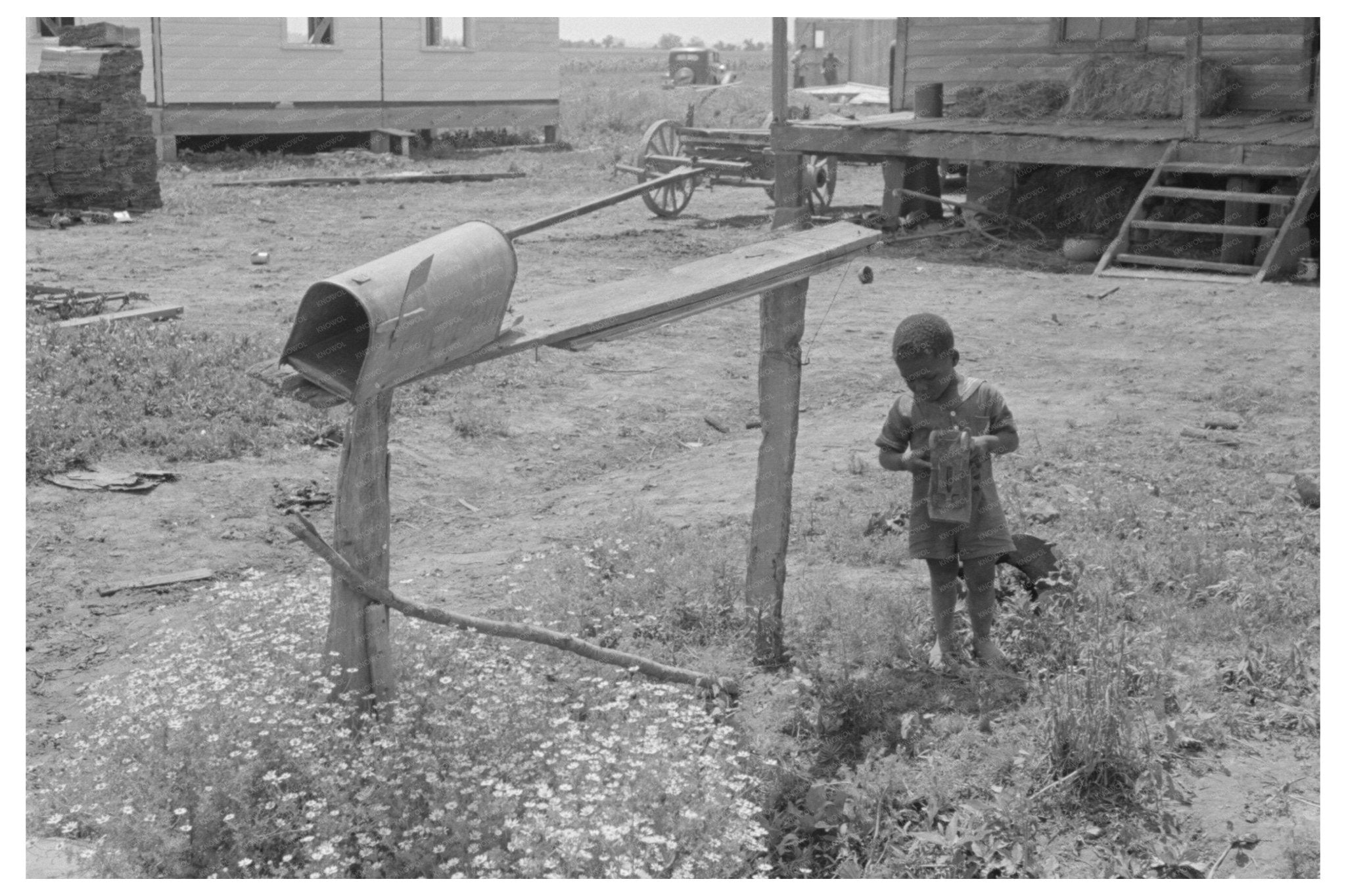 Child Playing with Toy by Mailbox in Southeast Missouri 1938 - Available at KNOWOL
