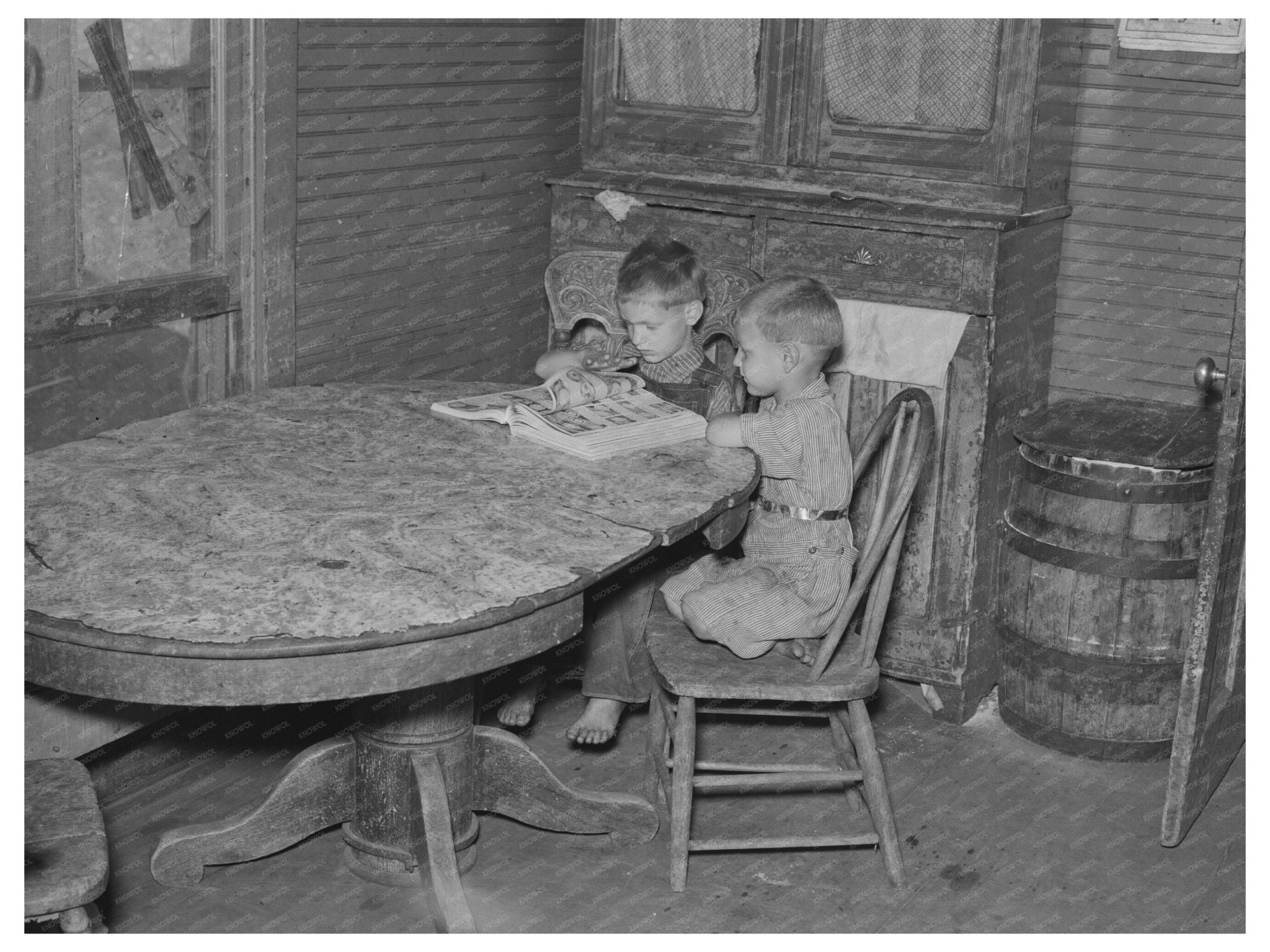 Children Looking Through Catalogue in Williston 1937 - Available at KNOWOL