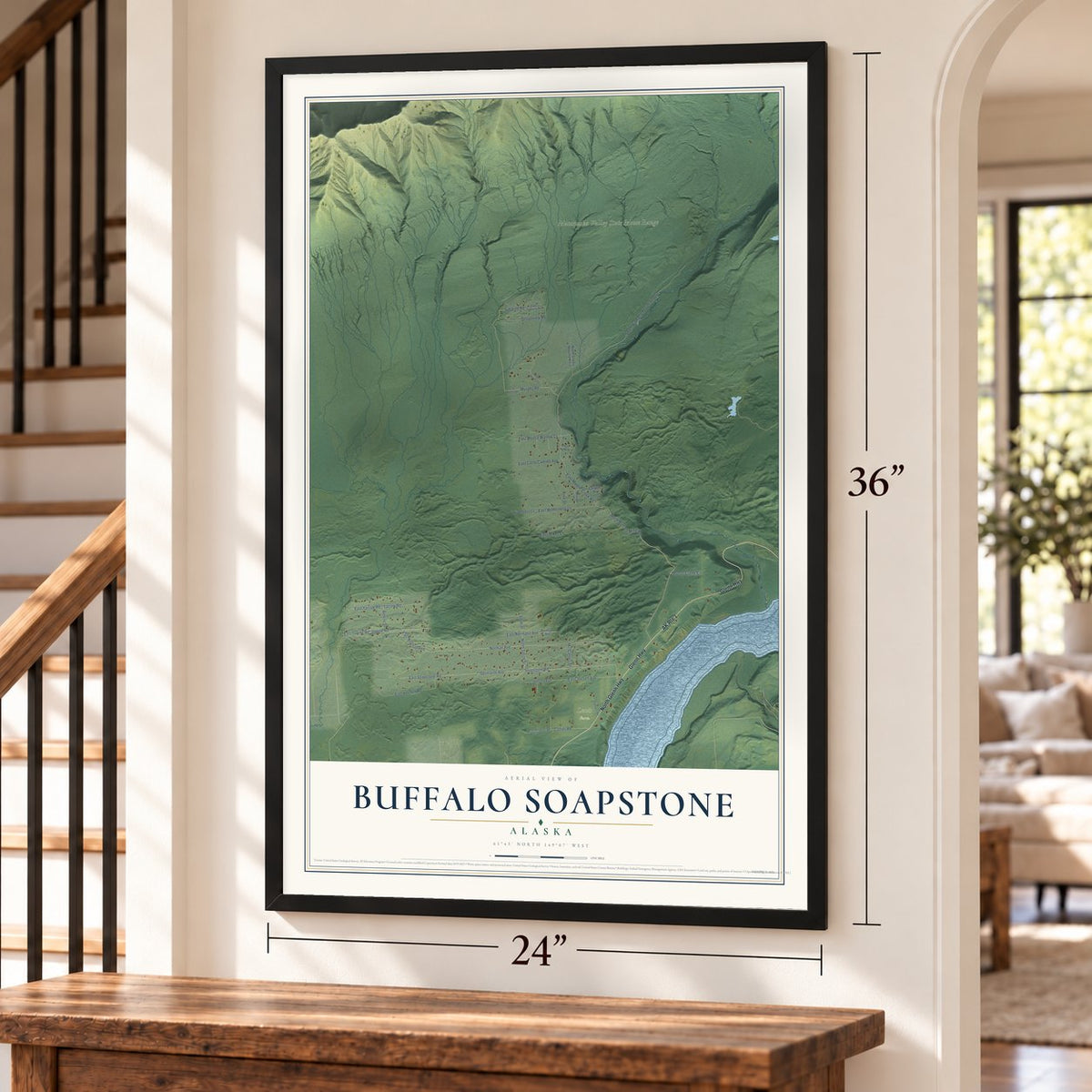 Buffalo Soapstone, Alaska map, 24 x 36 inch print in a black frame by a staircase