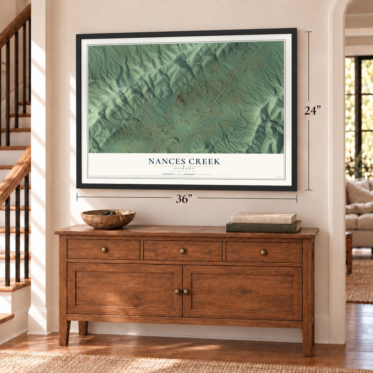 Nances Creek, Alabama map, 24 x 36 inch print in a black frame above a dresser by a staircase