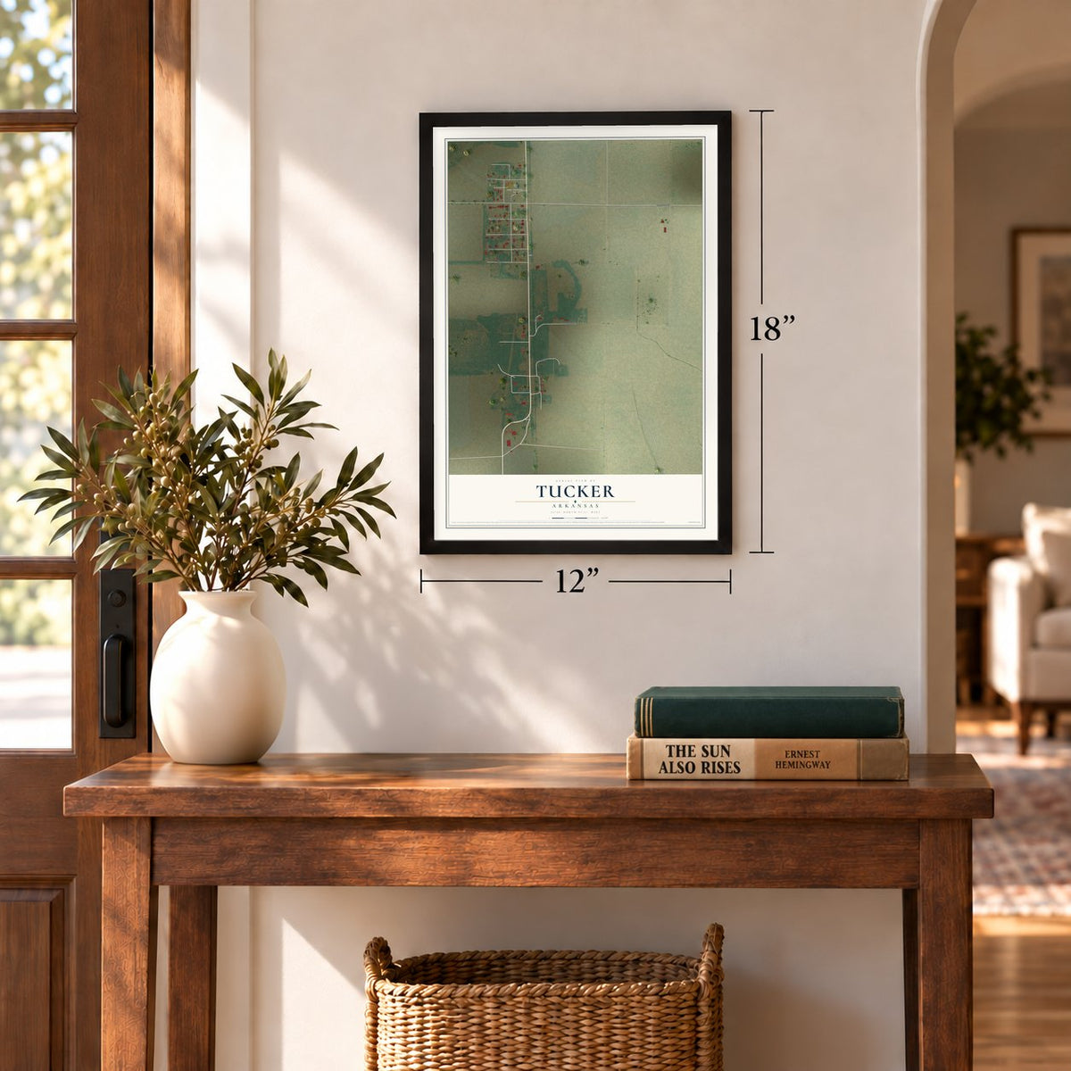 Tucker, Arkansas map, 12 x 18 inch print in a black frame in an entryway