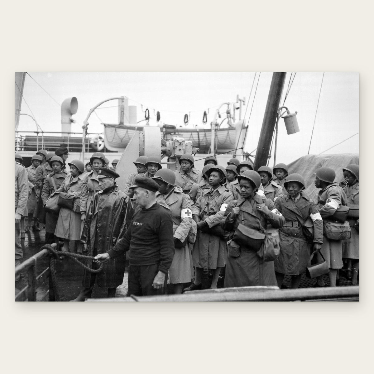 U.S. Army nurses in steel helmets and raincoats, many with red cross armbands, line a ship's rail at Greenock, Scotland, 1944, restored vintage photo print