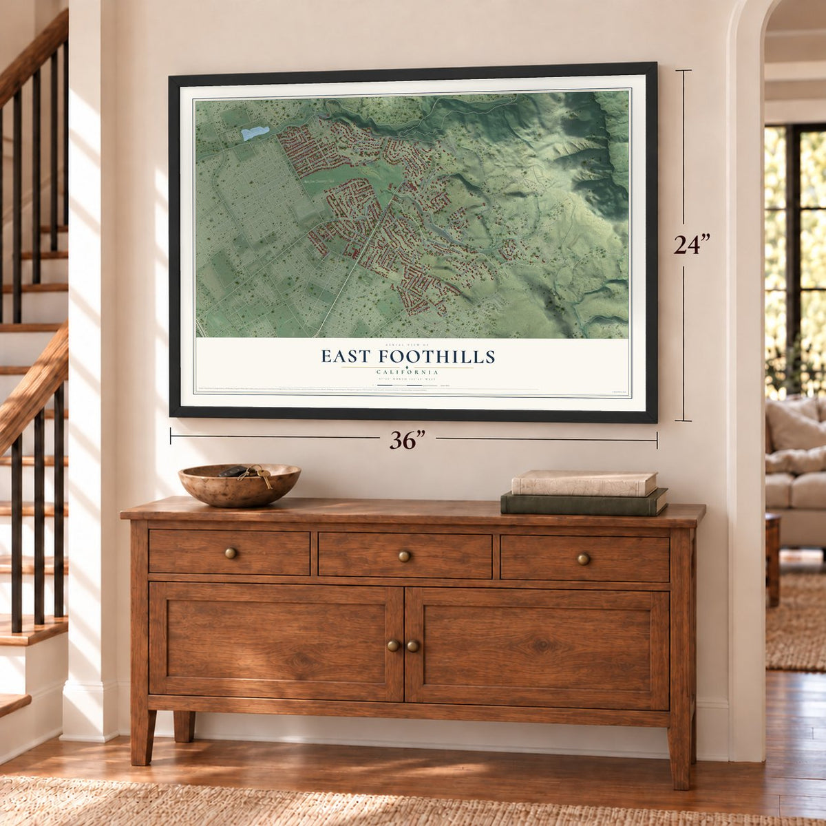 East Foothills, California map, 24 x 36 inch print in a black frame above a dresser by a staircase