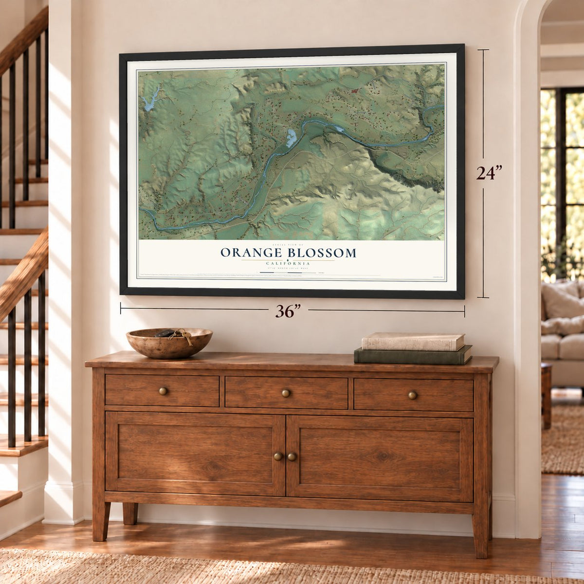 Orange Blossom, California map, 24 x 36 inch print in a black frame above a dresser by a staircase