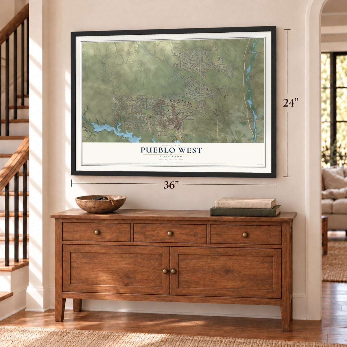 Pueblo West, Colorado map, 24 x 36 inch print in a black frame above a dresser by a staircase