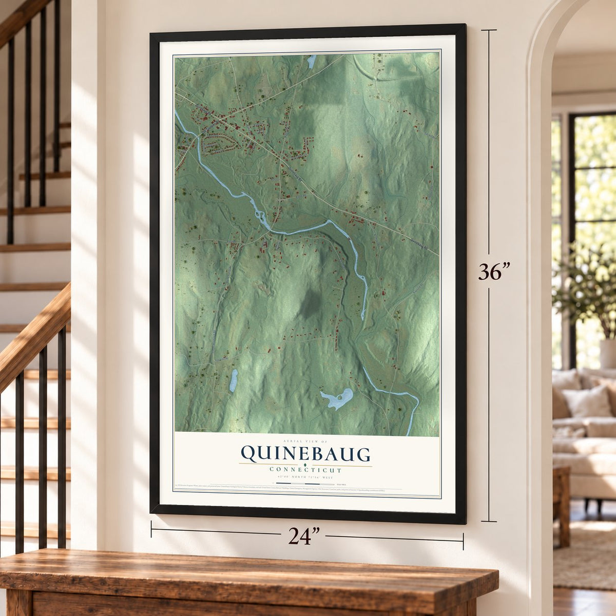Quinebaug, Connecticut map, 24 x 36 inch print in a black frame by a staircase