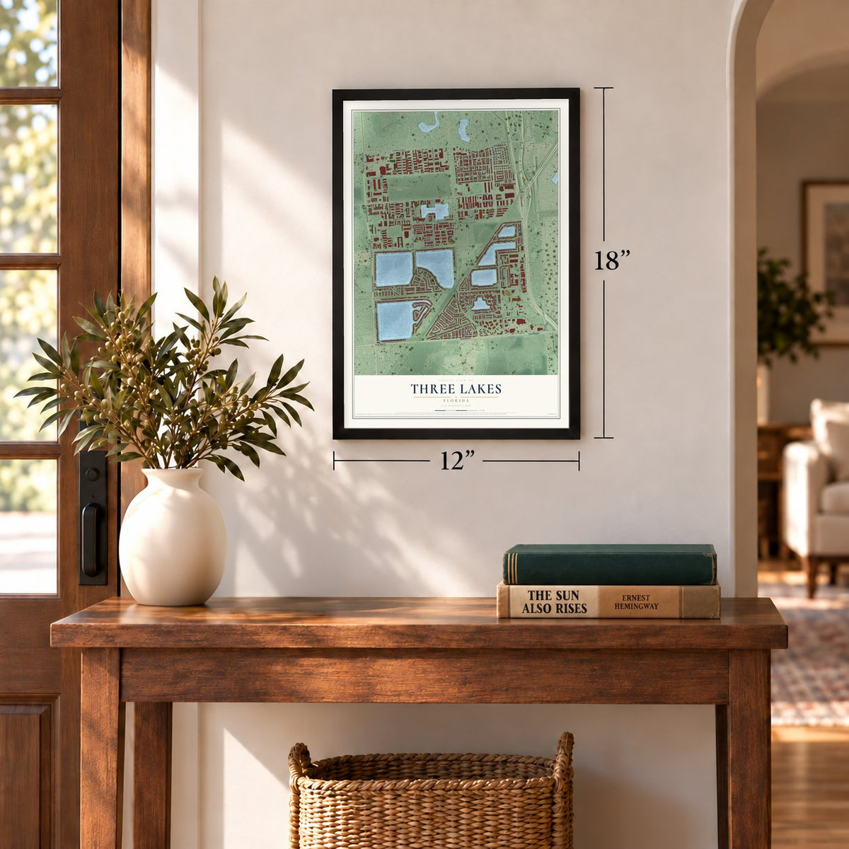 Three Lakes, Florida map, 12 x 18 inch print in a black frame in an entryway