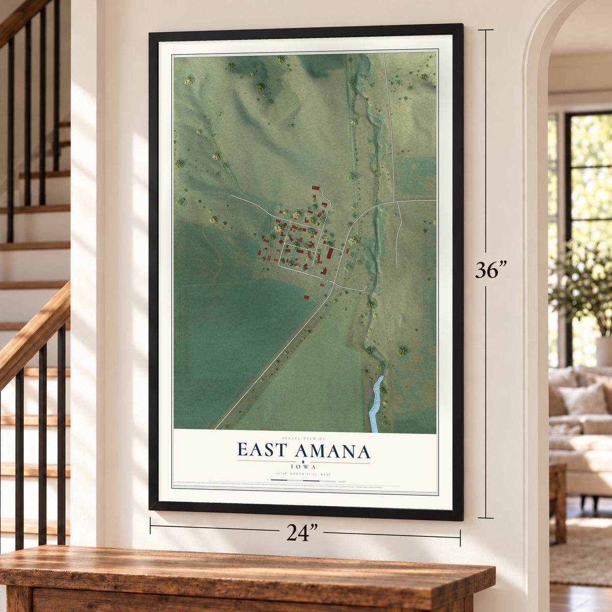 East Amana, Iowa map, 24 x 36 inch print in a black frame by a staircase