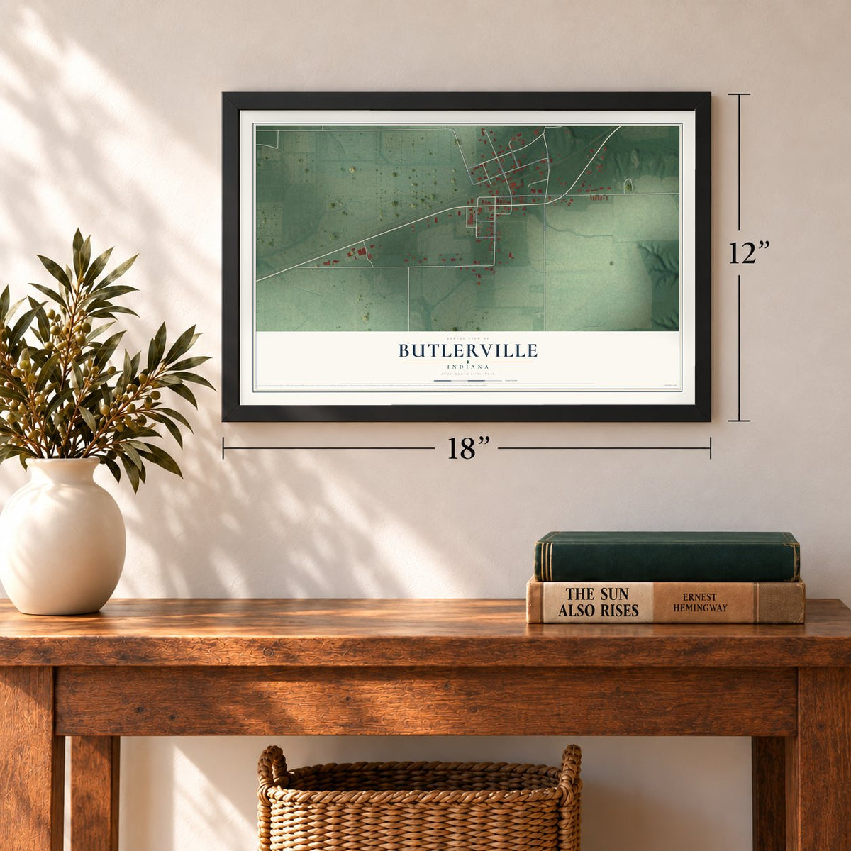 Butlerville, Indiana map, 12 x 18 inch print in a black frame in an entryway
