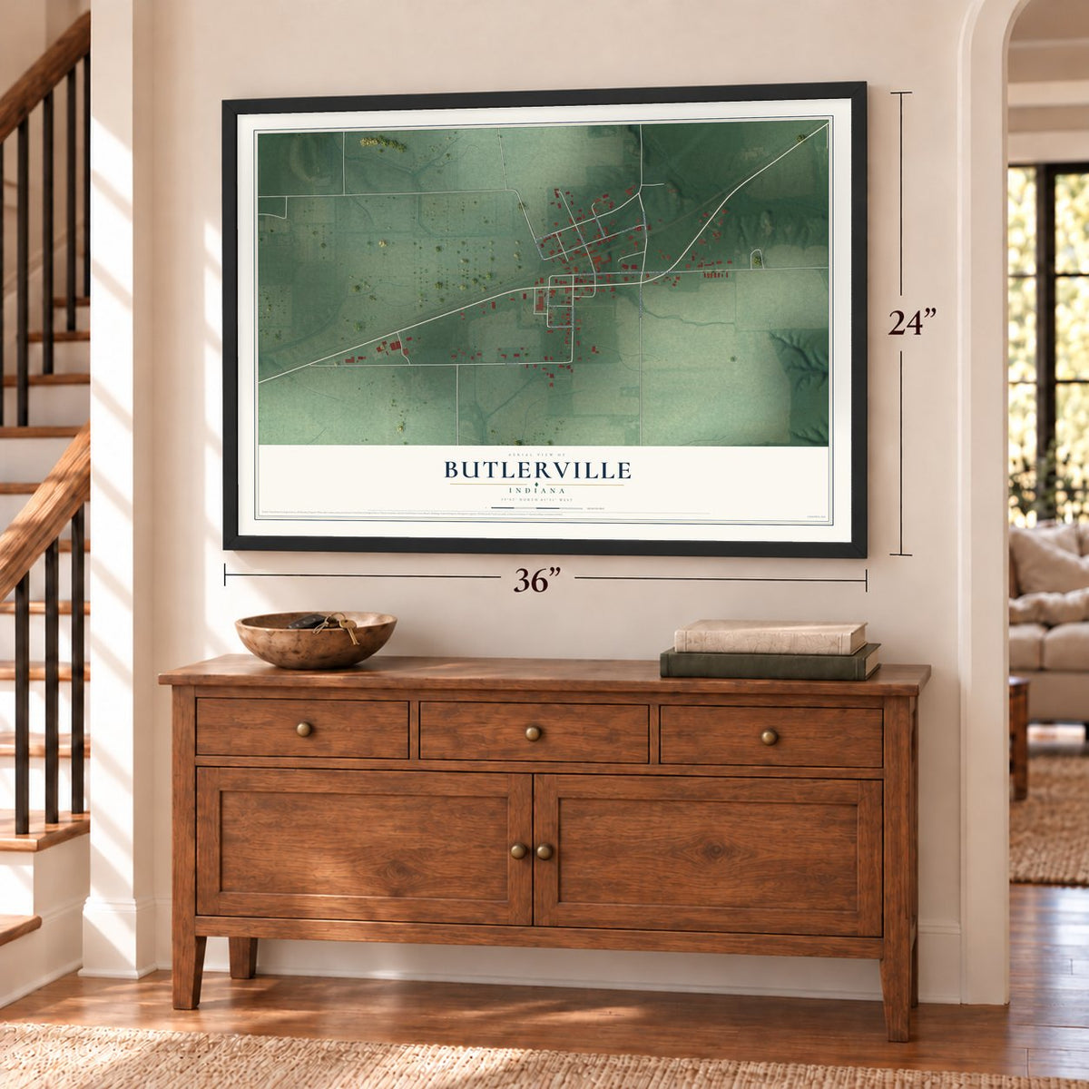 Butlerville, Indiana map, 24 x 36 inch print in a black frame above a dresser by a staircase