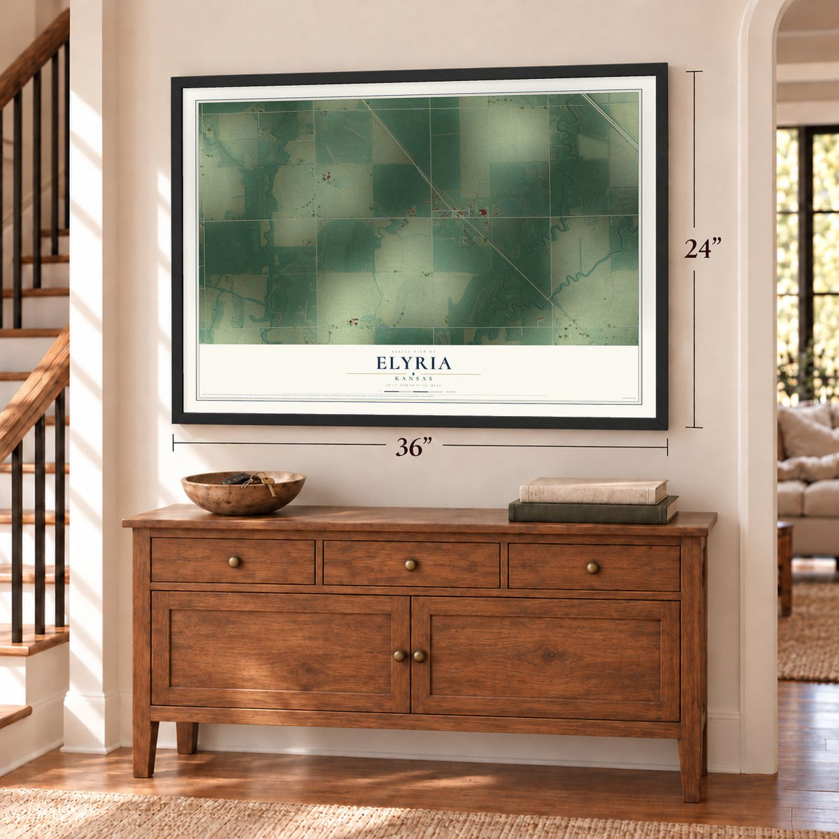 Elyria, Kansas map, 24 x 36 inch print in a black frame above a dresser by a staircase