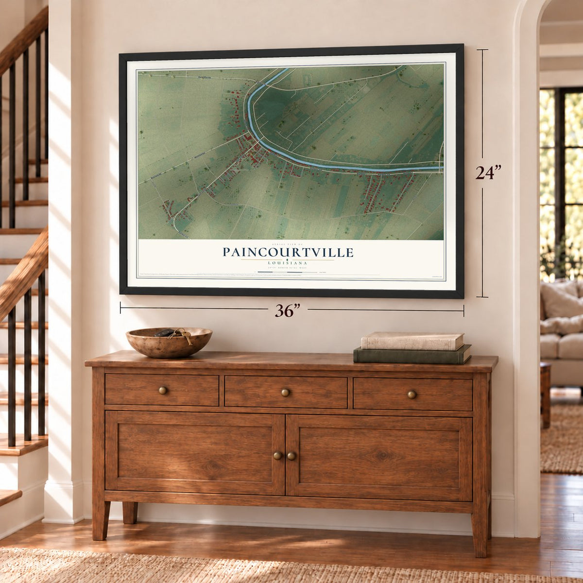 Paincourtville, Louisiana map, 24 x 36 inch print in a black frame above a dresser by a staircase