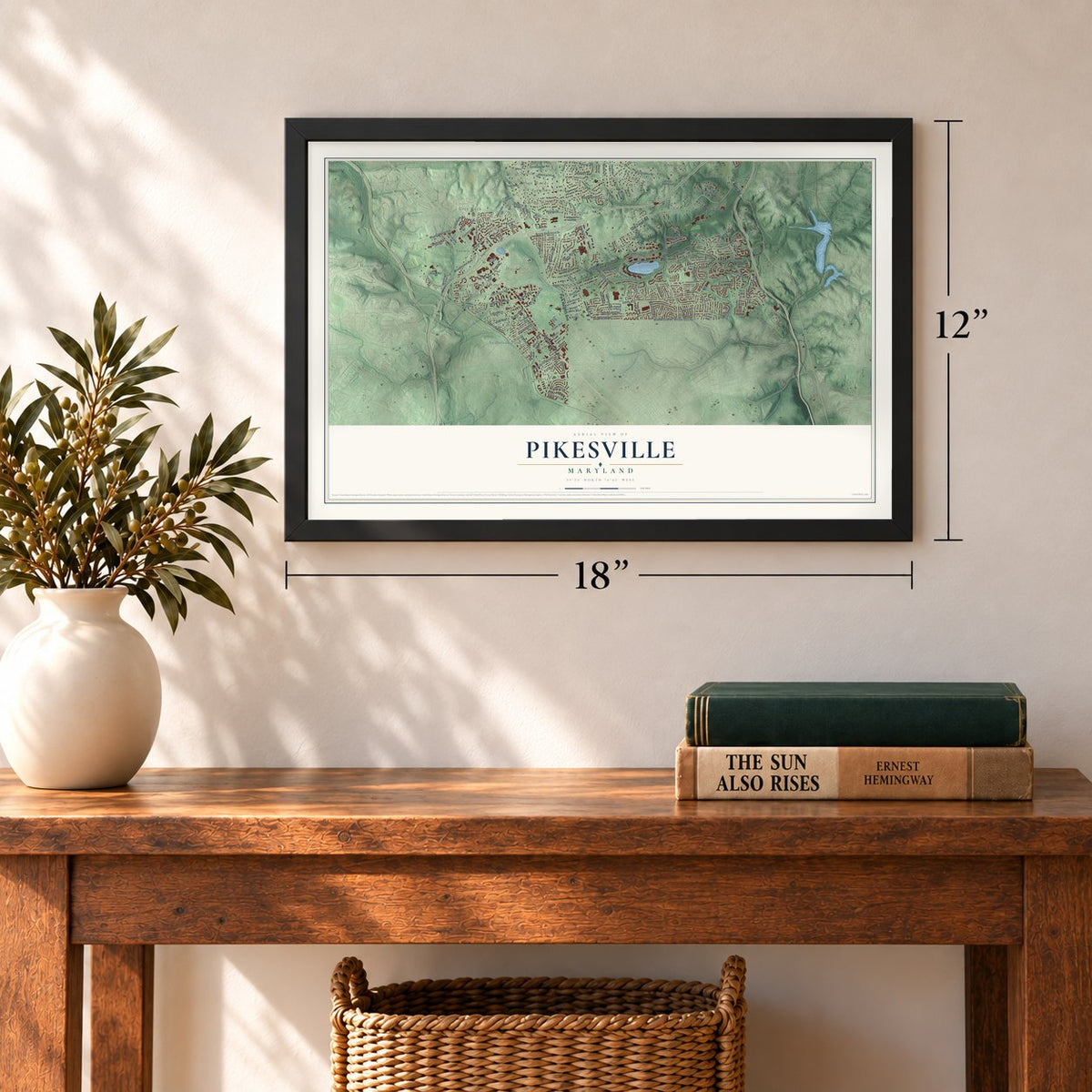 Pikesville, Maryland map, 12 x 18 inch print in a black frame in an entryway